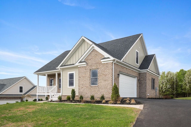 6913 Doral Dr, Radford, VA 24141 - craftsman house with board and batten siding, driveway, a front lawn, and covered porch