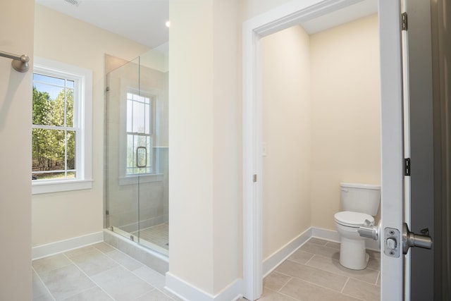 6913 Doral Dr, Radford, VA 24141 - bathroom featuring baseboards, toilet, a stall shower, and tile patterned floors