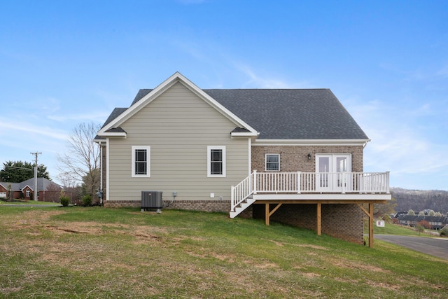 6913 Doral Dr, Radford, VA 24141 - back of house with a lawn, roof with shingles, a deck, and central AC
