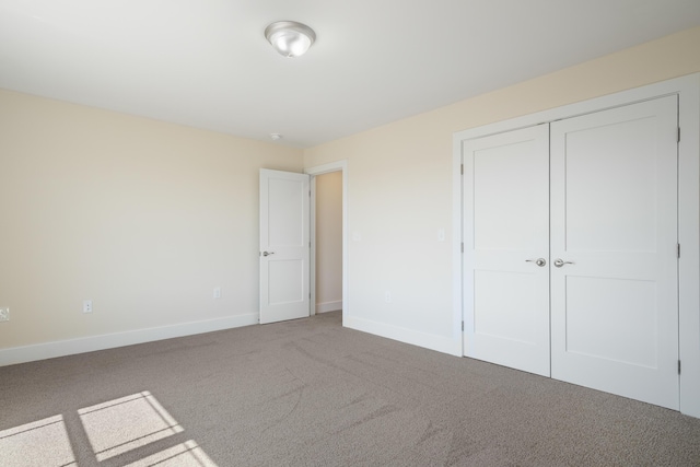 6913 Doral Dr, Radford, VA 24141 - unfurnished bedroom with baseboards, carpet flooring, and a closet
