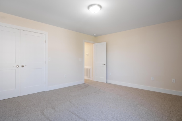 6913 Doral Dr, Radford, VA 24141 - unfurnished bedroom with a closet, carpet, visible vents, and baseboards