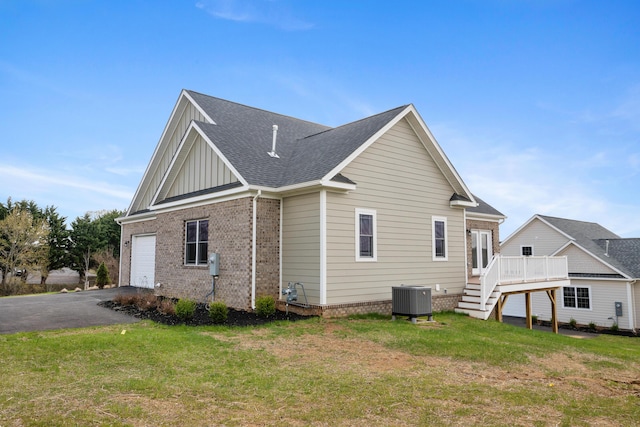 6913 Doral Dr, Radford, VA 24141 - view of side of property featuring a garage, central air condition unit, board and batten siding, driveway, and a deck
