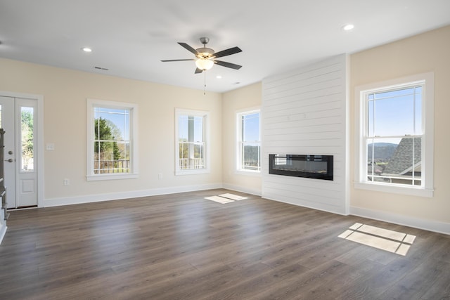 6913 Doral Dr, Radford, VA 24141 - unfurnished living room with a ceiling fan, baseboards, a fireplace, and dark wood-style flooring