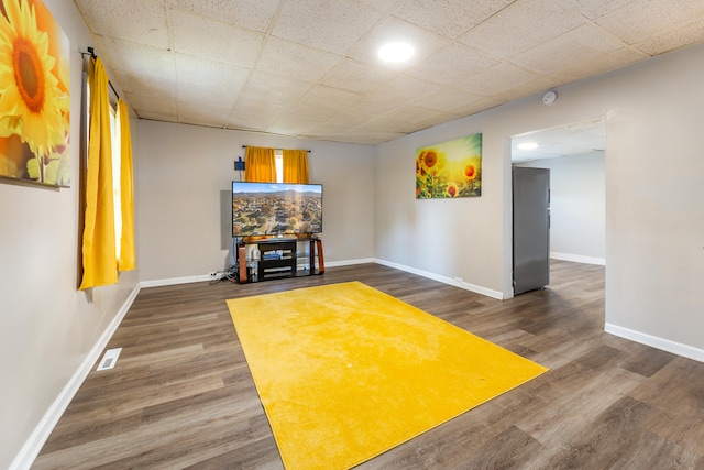 unfurnished living room with dark wood-type flooring