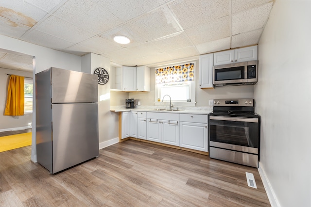 kitchen with white cabinetry, stainless steel appliances, and sink