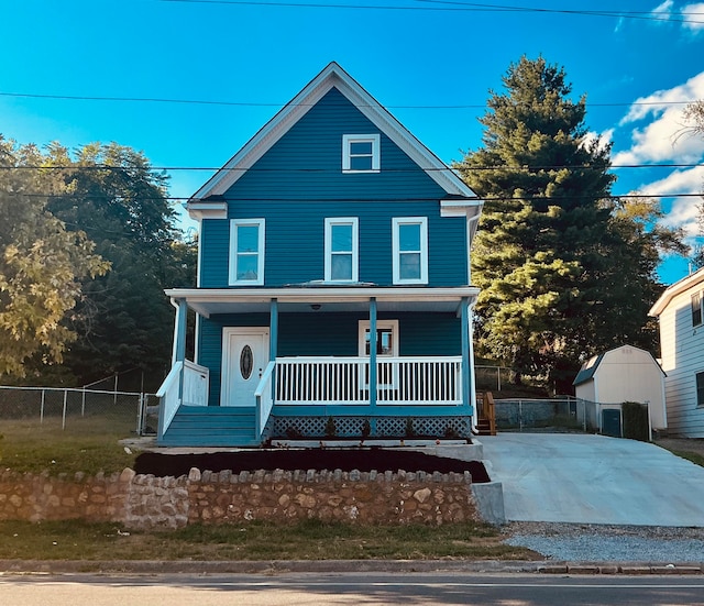 view of property with a shed and covered porch