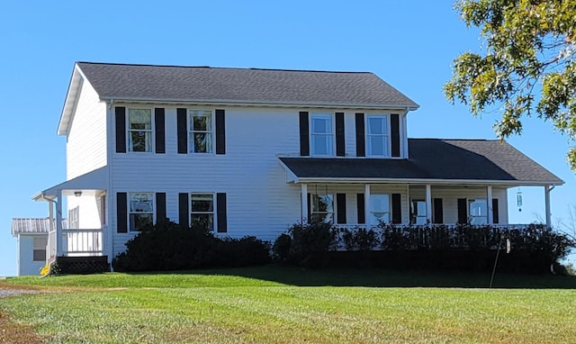 colonial-style house featuring a front lawn