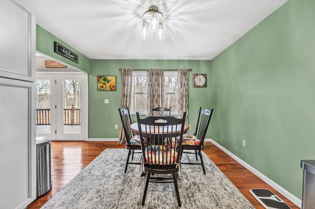 dining room featuring hardwood / wood-style floors and an inviting chandelier