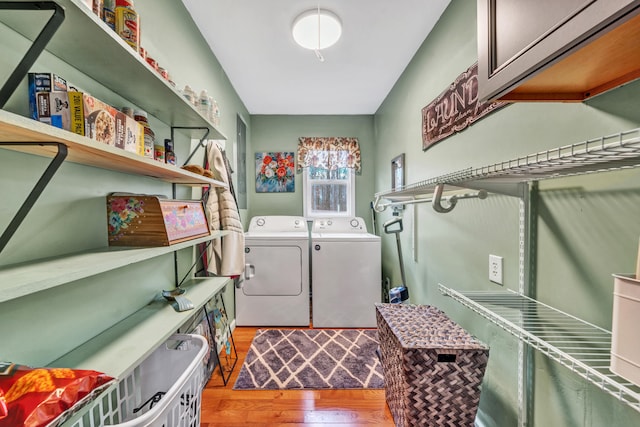 laundry room featuring light hardwood / wood-style flooring and washing machine and clothes dryer