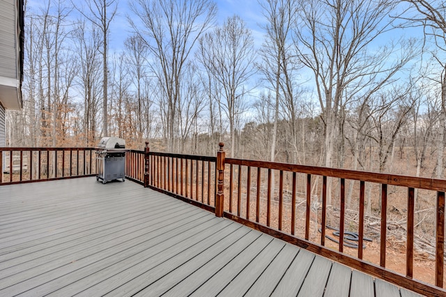 wooden deck featuring a grill