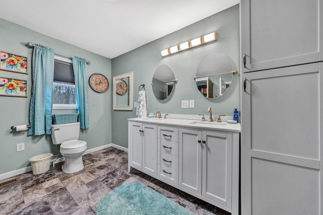 bathroom featuring toilet and vanity