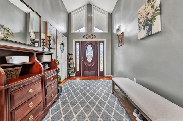 foyer with hardwood / wood-style flooring and vaulted ceiling