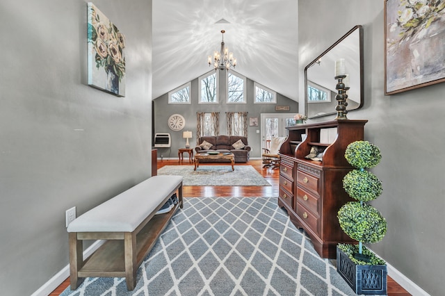 living room featuring a notable chandelier, hardwood / wood-style flooring, and lofted ceiling