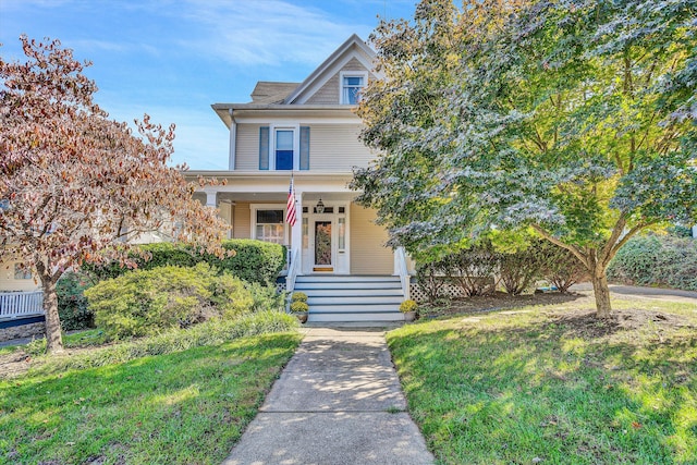 view of front of property featuring a front yard and covered porch