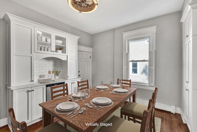 dining room with baseboard heating and dark wood-type flooring