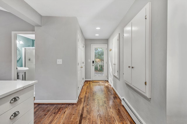 doorway featuring a baseboard radiator and dark hardwood / wood-style floors