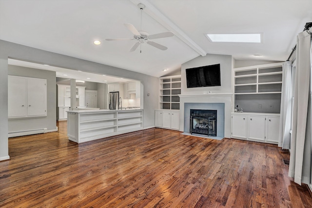 unfurnished living room featuring baseboard heating, a tile fireplace, lofted ceiling with beams, dark hardwood / wood-style flooring, and ceiling fan