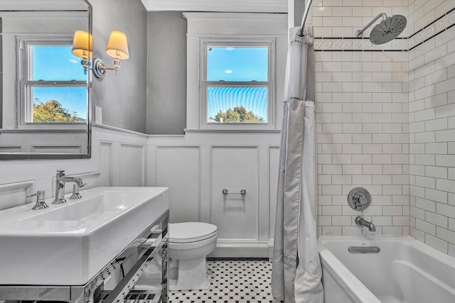 full bathroom with vanity, toilet, shower / bathtub combination with curtain, and a wealth of natural light