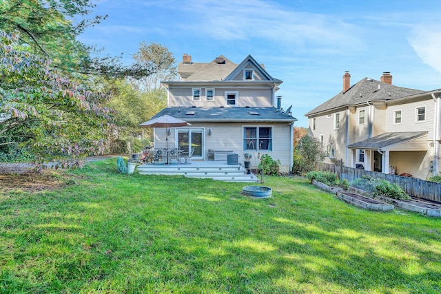 back of house featuring a yard and a deck