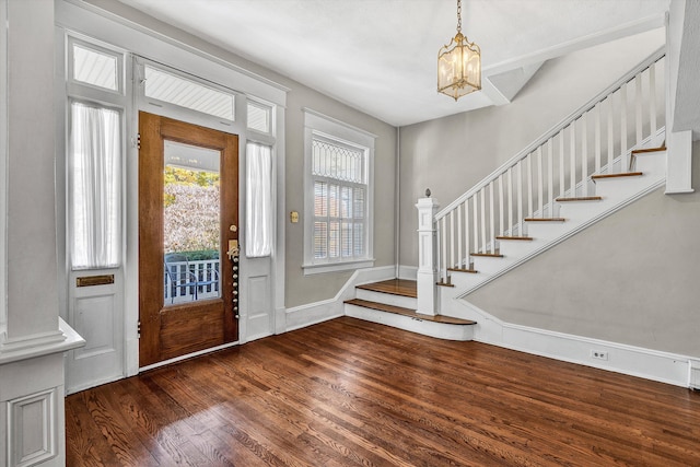 entrance foyer featuring a chandelier and dark hardwood / wood-style floors