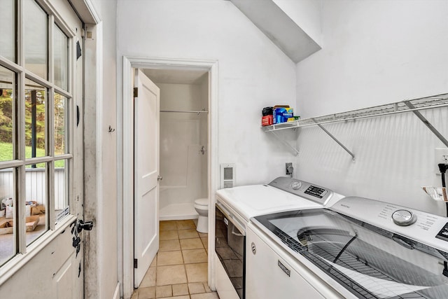 6869 Old Mill Rd, Roanoke, VA 24018 - clothes washing area with light tile patterned floors, plenty of natural light, laundry area, and washer and clothes dryer