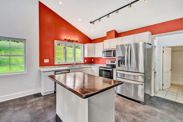 6869 Old Mill Rd, Roanoke, VA 24018 - kitchen featuring white cabinets, stainless steel appliances, a wealth of natural light, and a sink