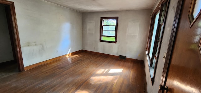 empty room featuring dark wood-type flooring