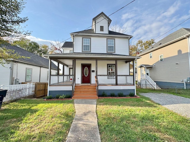 view of front of property featuring a front lawn and covered porch