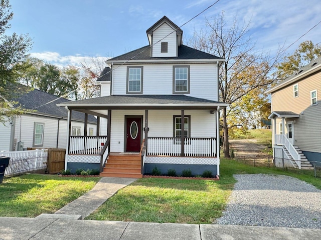 view of front of house with a front yard and a porch