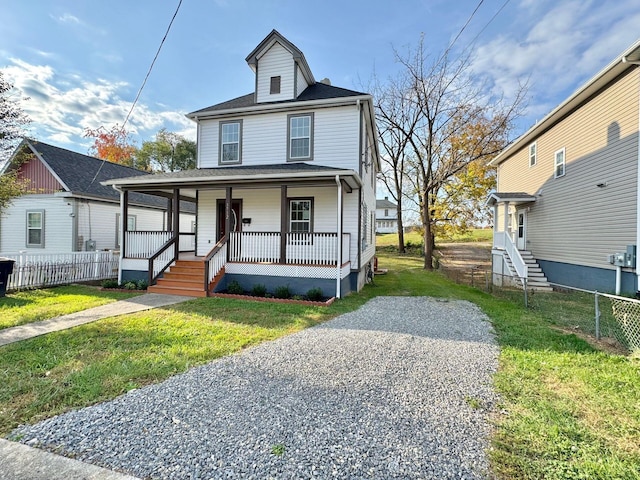 view of front of house featuring covered porch and a front lawn