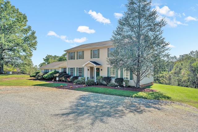 colonial-style house with a front lawn