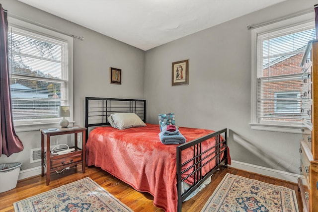 bedroom with wood-type flooring