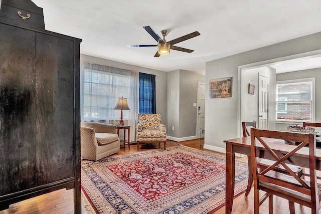 living area featuring ceiling fan and hardwood / wood-style floors