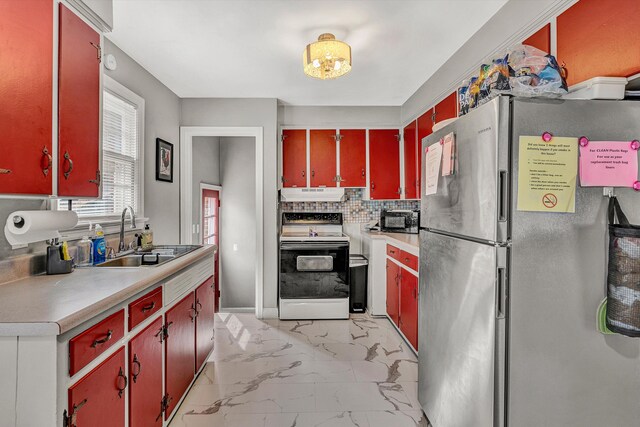 kitchen featuring white range with electric stovetop, decorative backsplash, sink, and stainless steel refrigerator