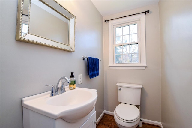 bathroom with vanity, hardwood / wood-style floors, and toilet