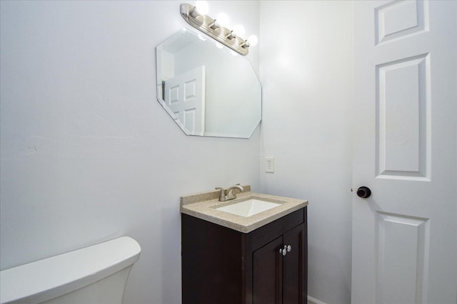 bathroom with toilet and vanity