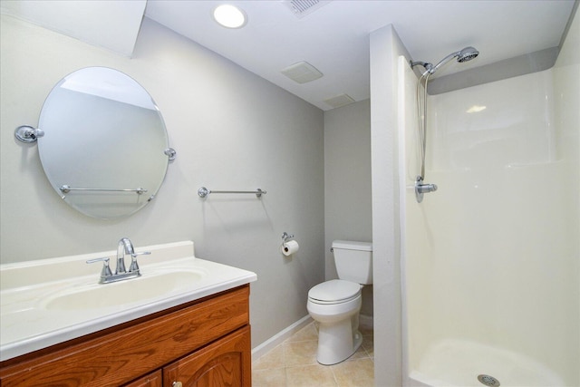 bathroom featuring vanity, a shower, toilet, and tile patterned flooring