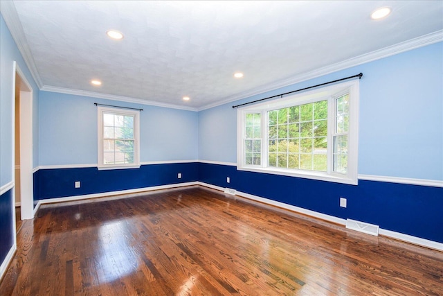 unfurnished room featuring dark wood-type flooring and ornamental molding