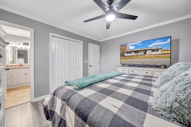 bedroom featuring ceiling fan, light wood-type flooring, crown molding, and connected bathroom