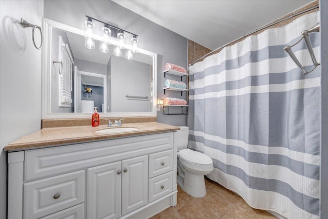 bathroom featuring tile patterned flooring, vanity, toilet, and curtained shower