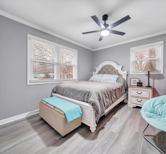 bedroom featuring ceiling fan, light hardwood / wood-style floors, and multiple windows