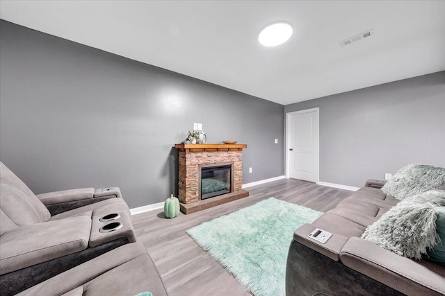 living room with a fireplace and hardwood / wood-style floors