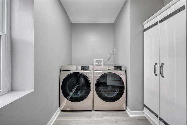 laundry area featuring light hardwood / wood-style flooring and independent washer and dryer