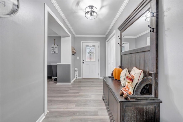 entryway featuring light hardwood / wood-style flooring and ornamental molding