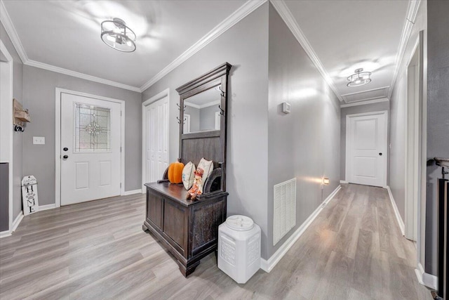 entryway featuring light wood-type flooring and crown molding