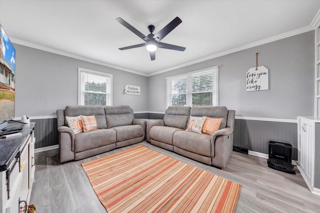 living room with light wood-type flooring, ceiling fan, and crown molding