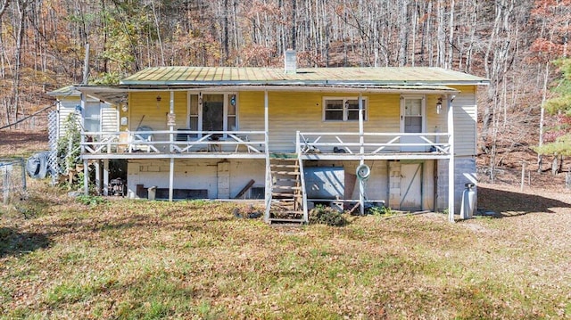 7820 Ogle Creek Rd, Covington, VA 24426 - rear view of house with stairway, covered porch, metal roof, a chimney, and a wooded view