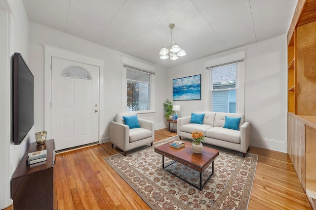 1132 Montrose Ave SE, Roanoke, VA 24013 - living room with a chandelier, light wood-style floors, and baseboards