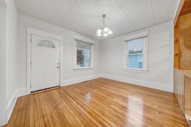 1132 Montrose Ave SE, Roanoke, VA 24013 - entrance foyer with a chandelier, light wood-type flooring, and baseboards