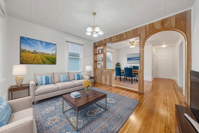 1132 Montrose Ave SE, Roanoke, VA 24013 - living room with a chandelier, arched walkways, light wood-style floors, ceiling fan, and baseboards